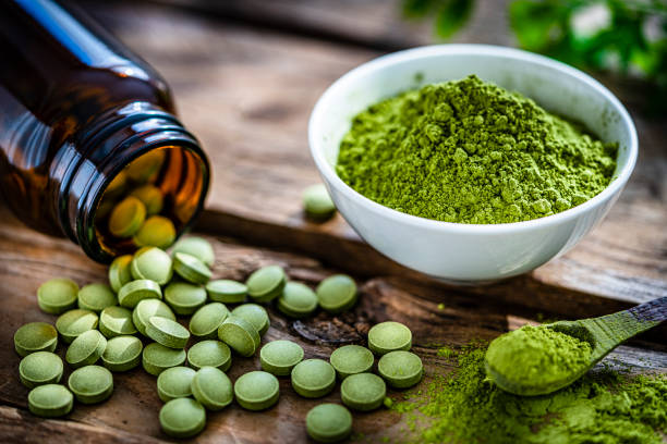 istock Dietary supplement: Moringa oleifera shot on wooden table 1335399984