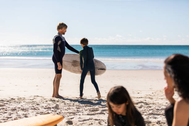 istock Aussie family on the beach getting ready for a surf 1335401331