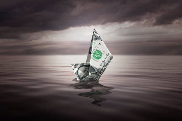 istock Sinking a little boat made with a dollar bill 1335402062