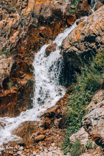 istock Water flows down from the slopes of the mountains. Small waterfall 1335402341
