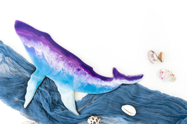 istock Resin art whale and sea shells on white background. Flat lay 1335402559