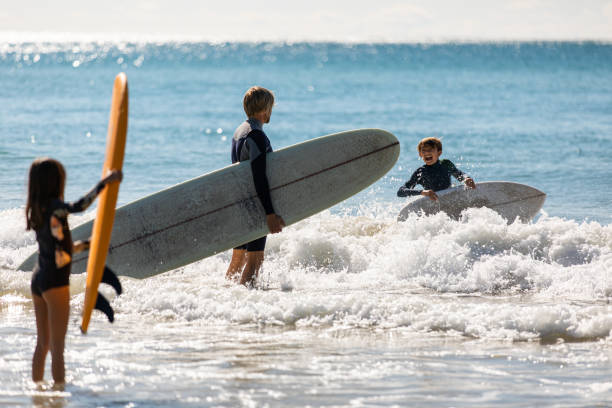 istock Aussie family heads into the water for a surf 1335403348