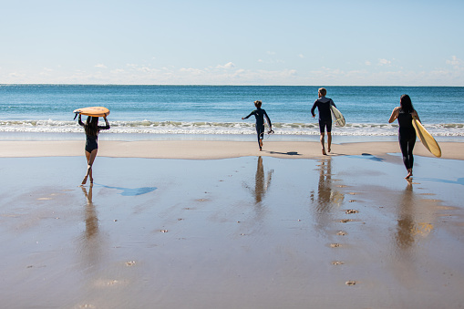 Real life Australian Japanese family gets ready to go surfing together