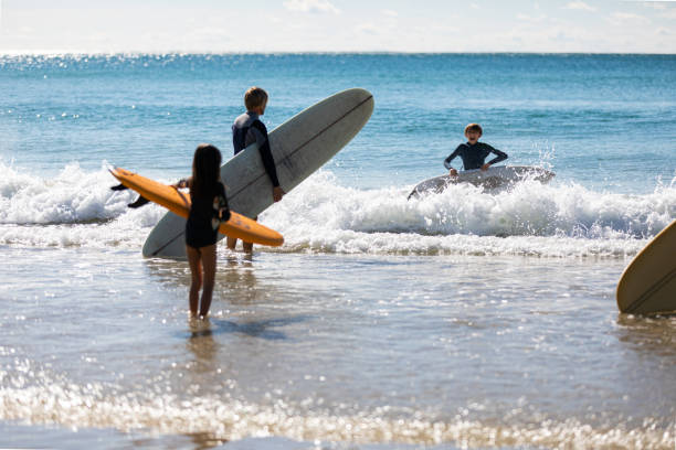 istock Aussie family heads into the water for a surf 1335403350
