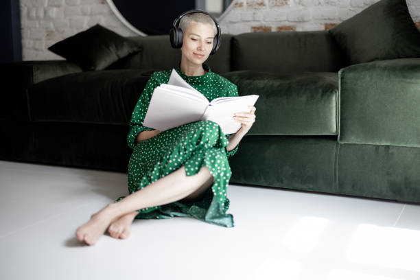 istock Woman reading book at home 1335403942