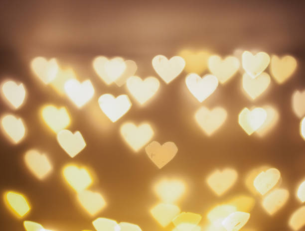 istock Abstract love concept:bokeh sparkling light in beautiful golden light colors for design,web,text,Christmas,love,beautiful heart-shaped background 1335404717