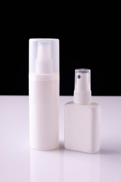 istock white aerosol bottles on white table and black background 1335404999