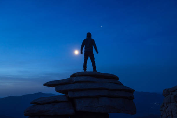 istock A man stood on a stone and looked up at the moon 1335405001