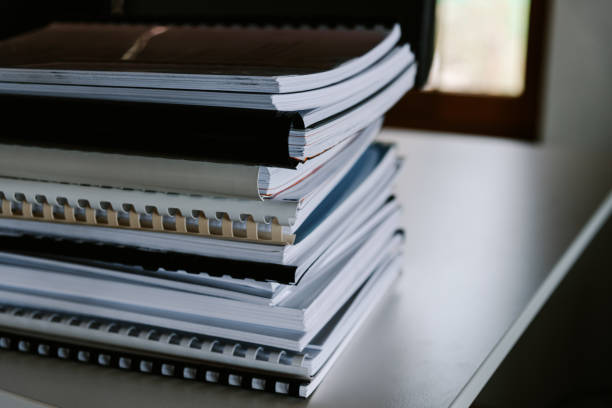 istock Stack of reports lies on a desk ready for review 1335406080