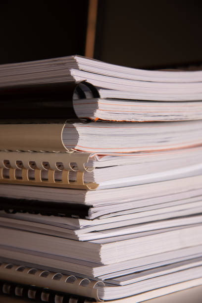 istock Stack of reports lies on a desk ready for review 1335406098
