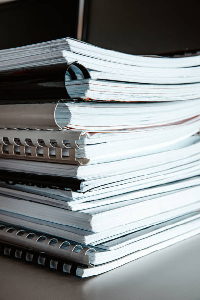 istock Stack of reports lies on a desk ready for review 1335406996