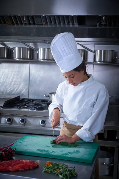 istock Chef woman portrait cutting at kitchen 1335407000
