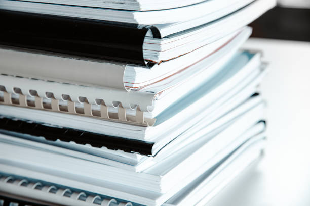 istock Stack of reports lies on a desk ready for review 1335407006