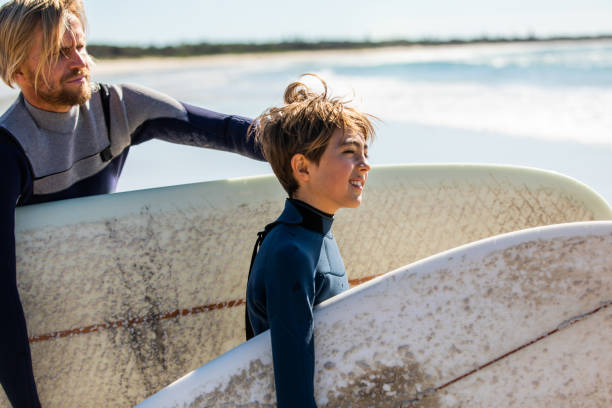 istock Father and son go surfing together 1335407719
