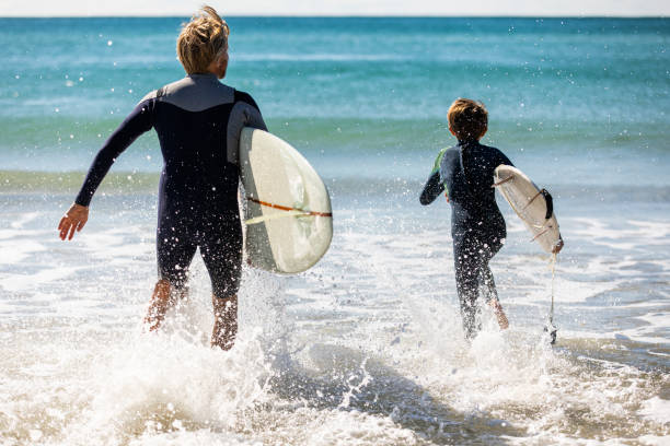 istock Father and son go surfing together 1335407733