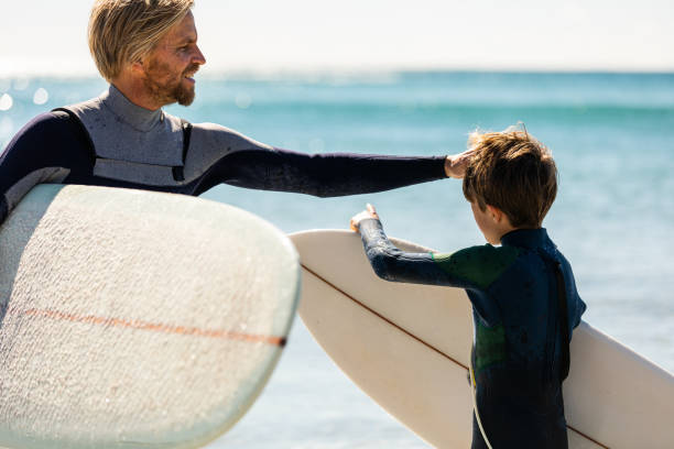 istock Father and son go surfing together 1335407749
