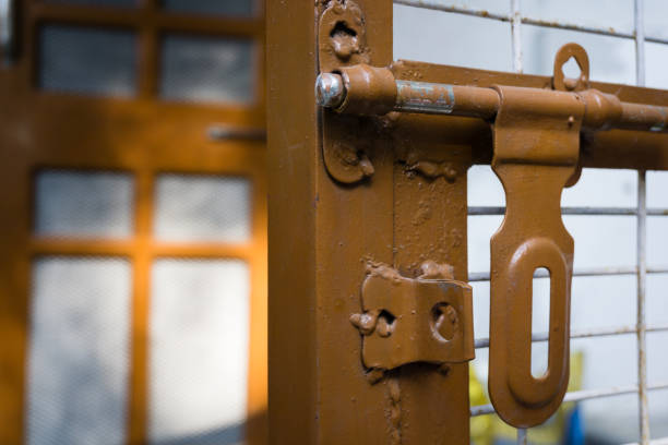 A close-up shot of a big gate latch. Gate lock, manual gate latch.