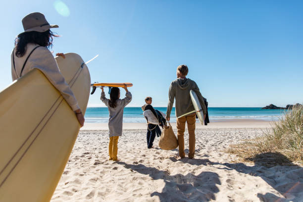 istock Young family goes for a surf together 1335409659