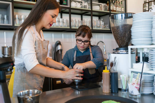 istock Young woman with Down Syndrome working at cafe 1335410150
