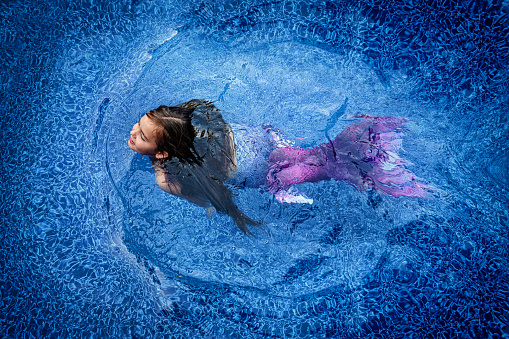 A little 7 years old dreaming to be a mermaid