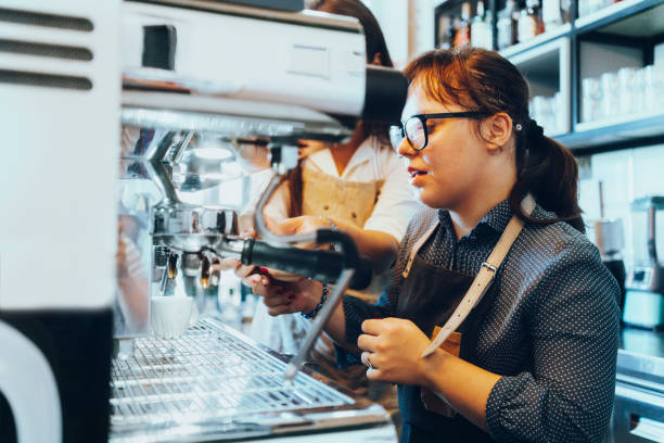 istock Young woman with Down Syndrome working at cafe 1335412991
