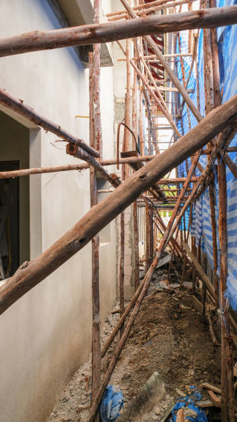 istock strong wooden scaffolding install use for high level.  concrete wall plaster cement on wall for building new house. 1335414524
