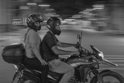 Recife, Pernambuco, Brazil - August 13, 2021:Couple on a motorcycle passing by Marco Zero town square.