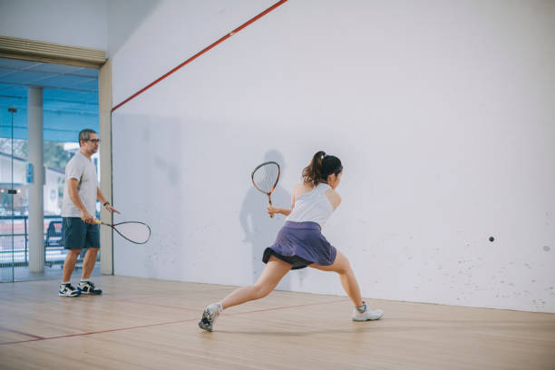 istock Asian squash coach father guiding teaching his daughter squash sport practicing together in squash court 1335419046