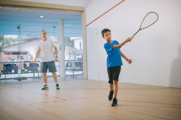 istock young Asian malay male squash player practicing with guidance from his coach 1335419181