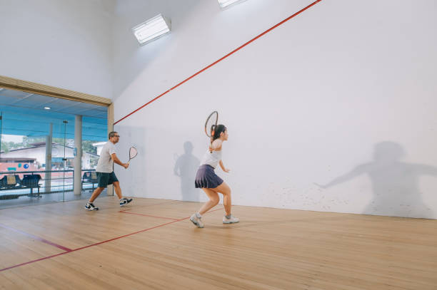 istock Asian squash coach father guiding teaching his daughter squash sport practicing together in squash court 1335419765