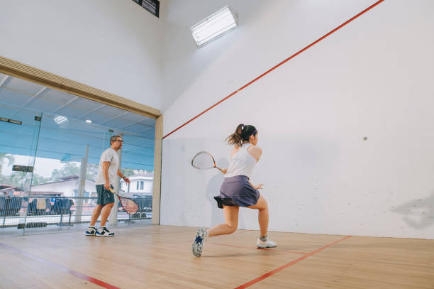 istock Asian squash coach father guiding teaching his daughter squash sport practicing together in squash court 1335419776