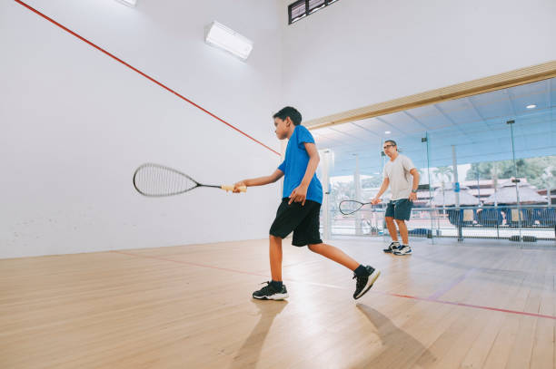 istock young Asian malay male squash player practicing with guidance from his coach 1335420309