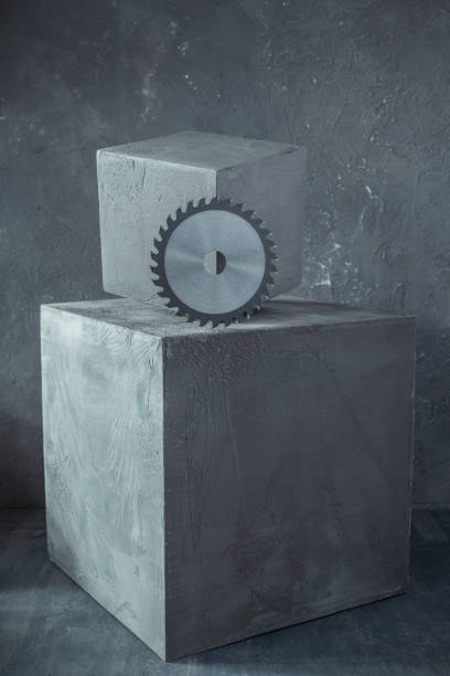 istock Circular saw blade on concrete cube or cement block background texture 1335420532
