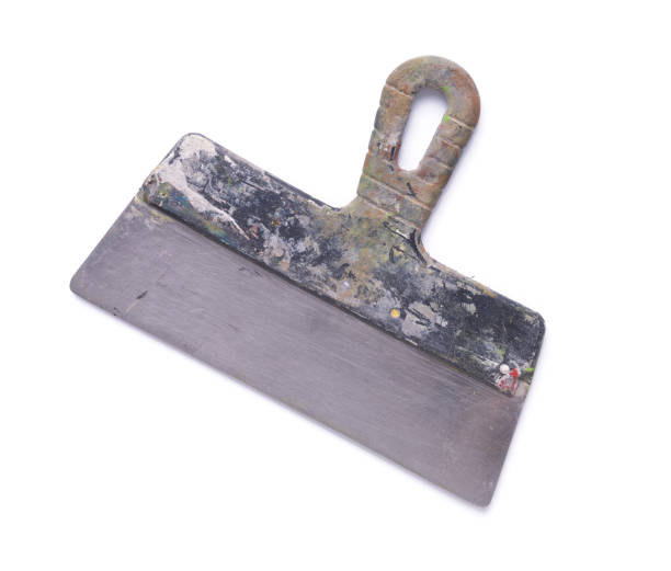 Old used putty knife tool isolated on white background. Construction tool for house room renovation