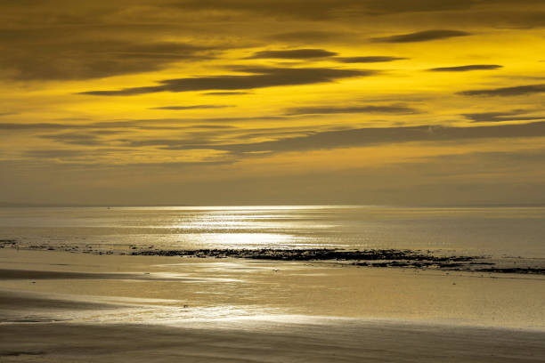 Sunset on an autumn day on a beach at low tide