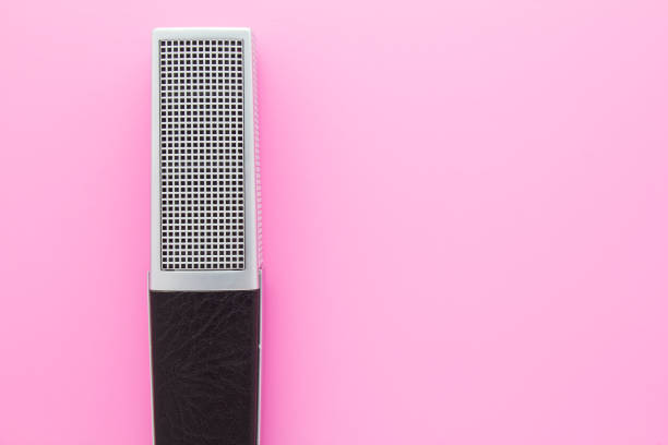 Professional vocal retro microphone on pink background with copy space for text. stock photo