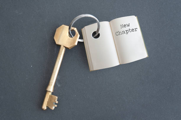 New chapter Keyring with open book and chapter one on a chalkboard keyring charm stock pictures, royalty-free photos & images