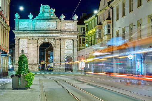 Innsbruck, Austria - August 06, 2021: night view of the Triumphpforte, a triumphal arch built in 1765 in Maria-Theresien-Strasse to commemorate the wedding of Archduke Leopold.