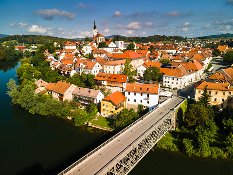 Novo Mest Old Bridge on River Krka in Slovenia. Red Roof  City Skyline Aerial Drone Vew.