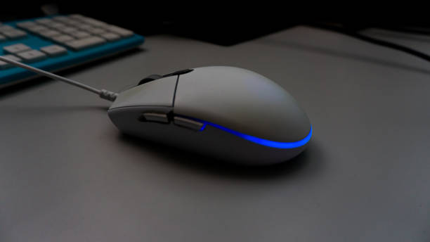 istock White RGB led gaming mouse on the table. 1335424663