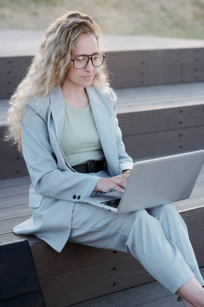 istock Young serious student or businesswoman using laptop 1335426287