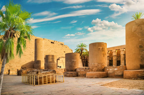 Luxor Karnak temple and palm Luxor Karnak temple. The pylon with blue sky and palm luxor thebes stock pictures, royalty-free photos & images