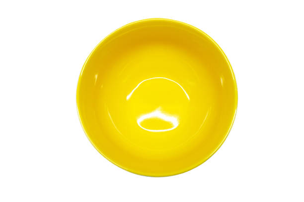 istock Top view yellow empty clean round ceramic deep soup porridge dishes isolated white background with copy space. place to copy. plate in a minimalist style. Conceptual layout for labeling and placement 1335430763