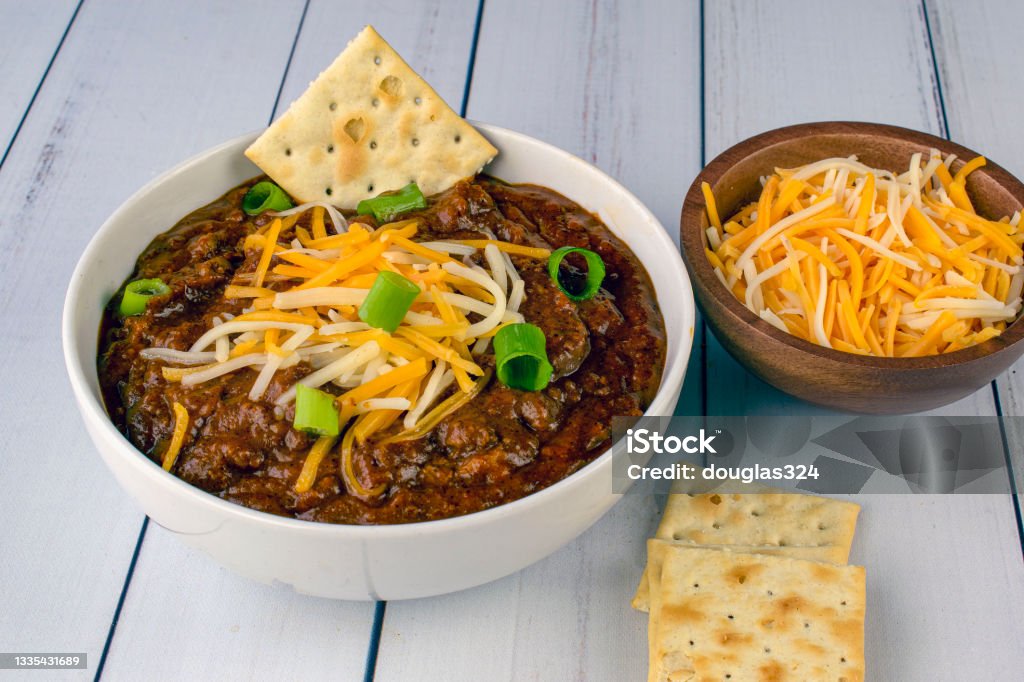 chili top with cheese  and green onions bowl of chili top with cheese and green onions Chili Con Carne Stock Photo