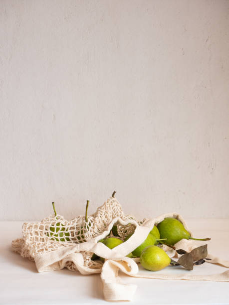 istock Ripe garden green pears in a light cotton string bag on a white background 1335432961