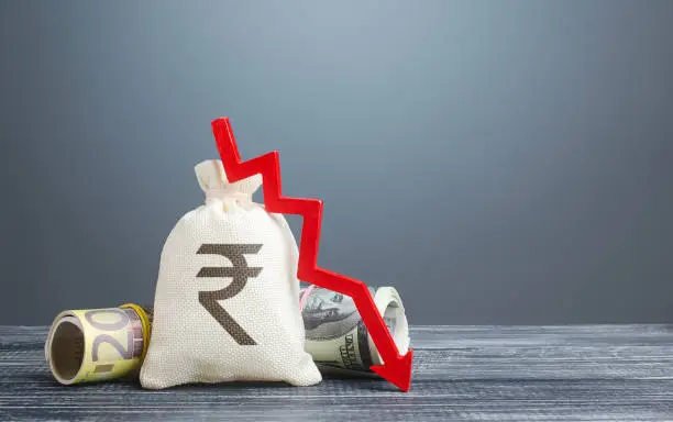 Indian rupee money bag and red arrow down. Economic difficulties. Capital flight, high risks. Costs expenses. Crisis, loss savings. Stagnation, recession, declining business activity, falling wealth.
