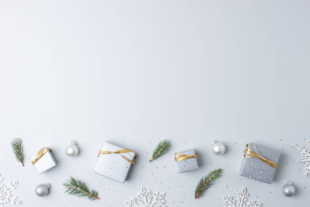 istock Christmas decorations with packaging gifts and Christmas tree on grey background. Flat lay, copy space 1335438789