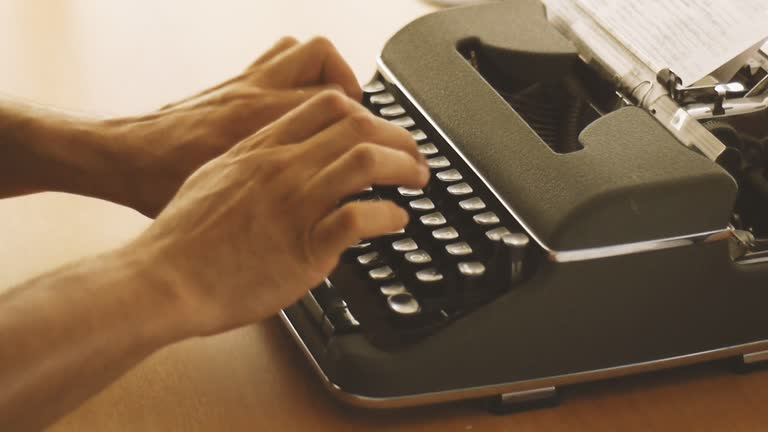 Man Types Something With A Typewriter