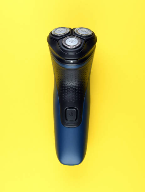istock Electric shaver with three shaving heads on a yellow background. 1335439907