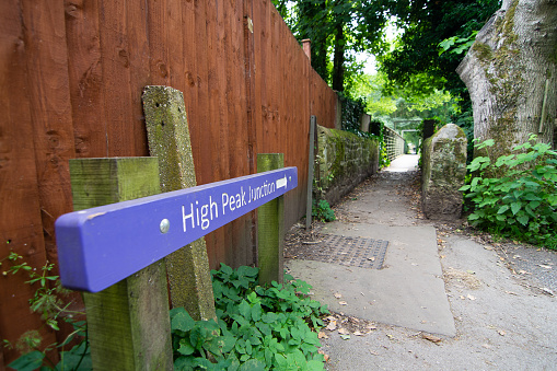 A purple sign post pointing the way to High Peak Junction near Cromford Canal in Derbyshire